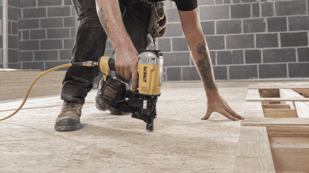 What Is a Coil Nail Gun? Best Coil Nailers & Coil Nailer vs Strip Nailer Explained 1 Flooring installation with a coil nailer